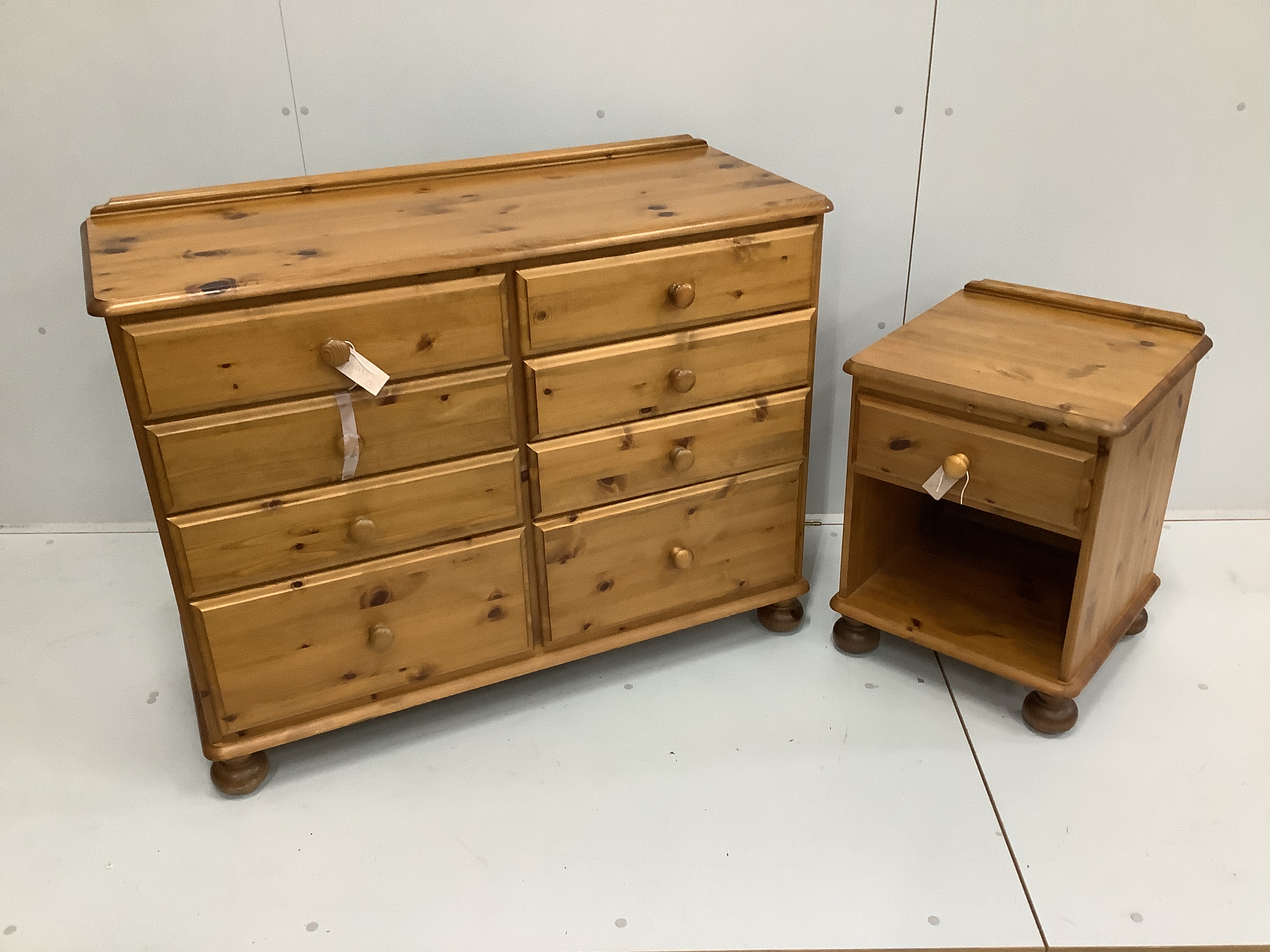 A 'Victoria' pine double chest with eight drawers, width 110cm, depth 45cm, height 76cm and a matching bedside chest
